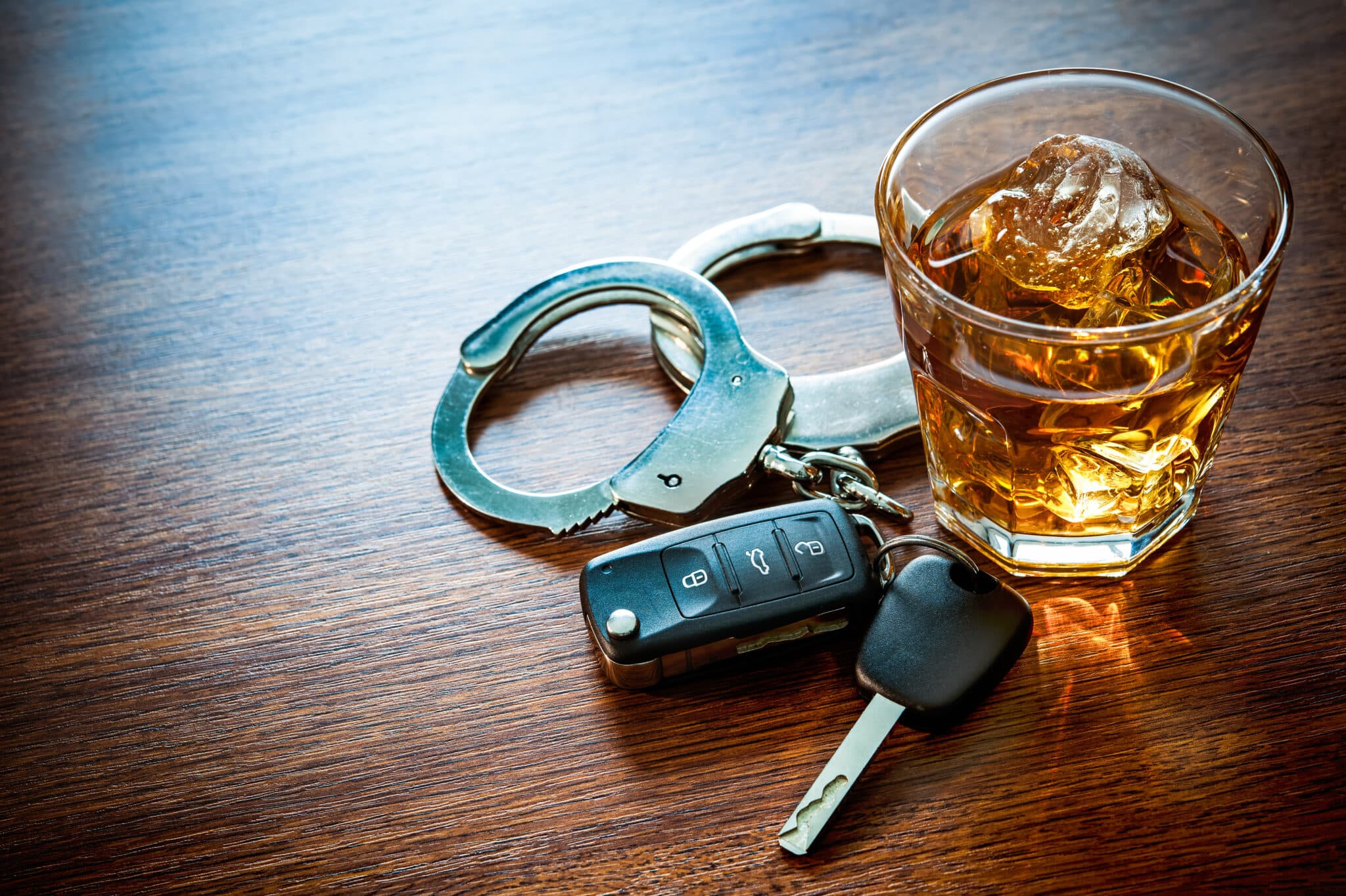 Whiskey with car keys and handcuffs. Representing drunk driving. Missouri DUI defense Lawyers